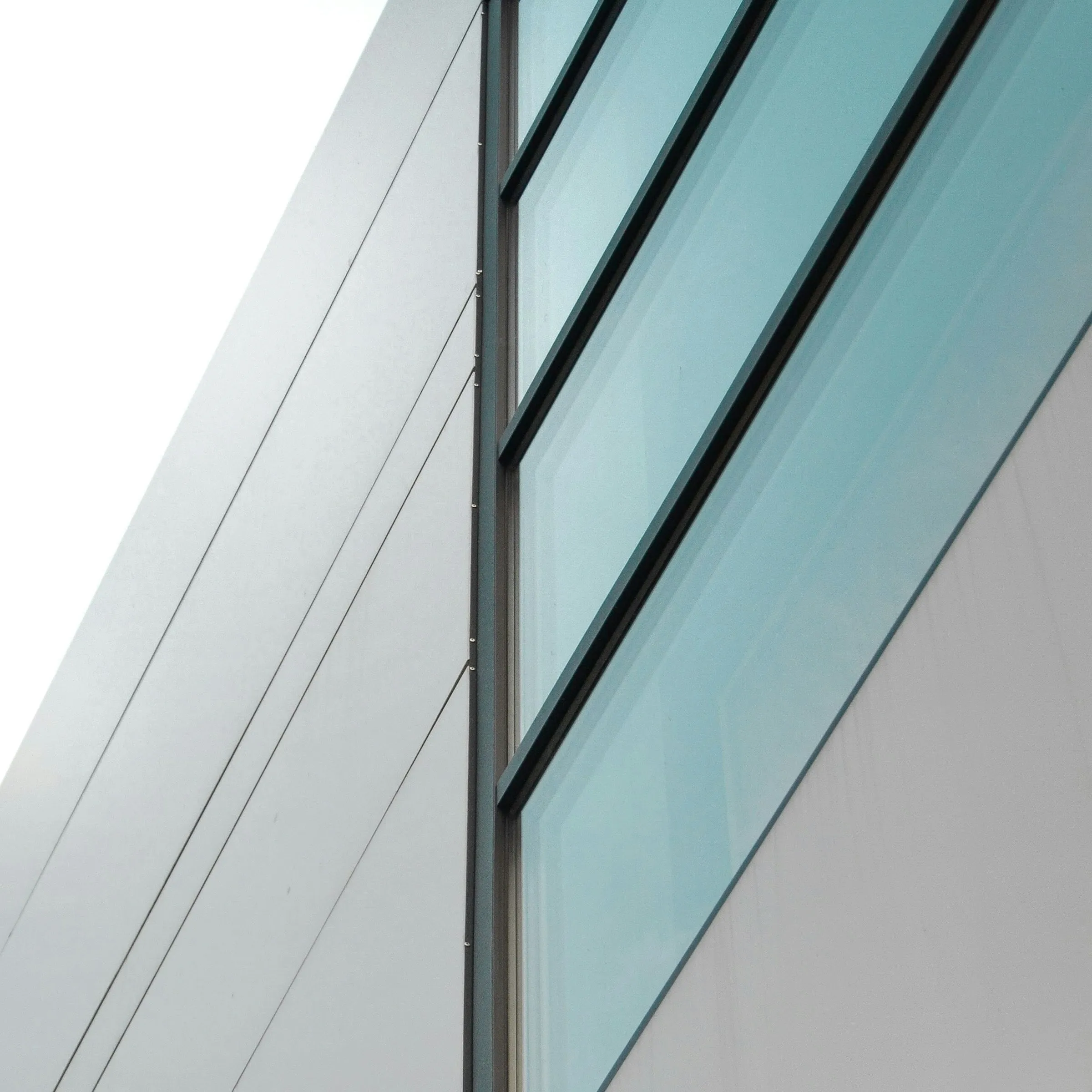 Detail of glazing and window profiles running along a building facade